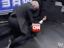 Still image from gif of Trump tackling the CNN logo